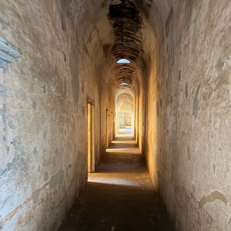 SDLC_01 cover, a warmly lit stone corridor with a vaulted ceiling